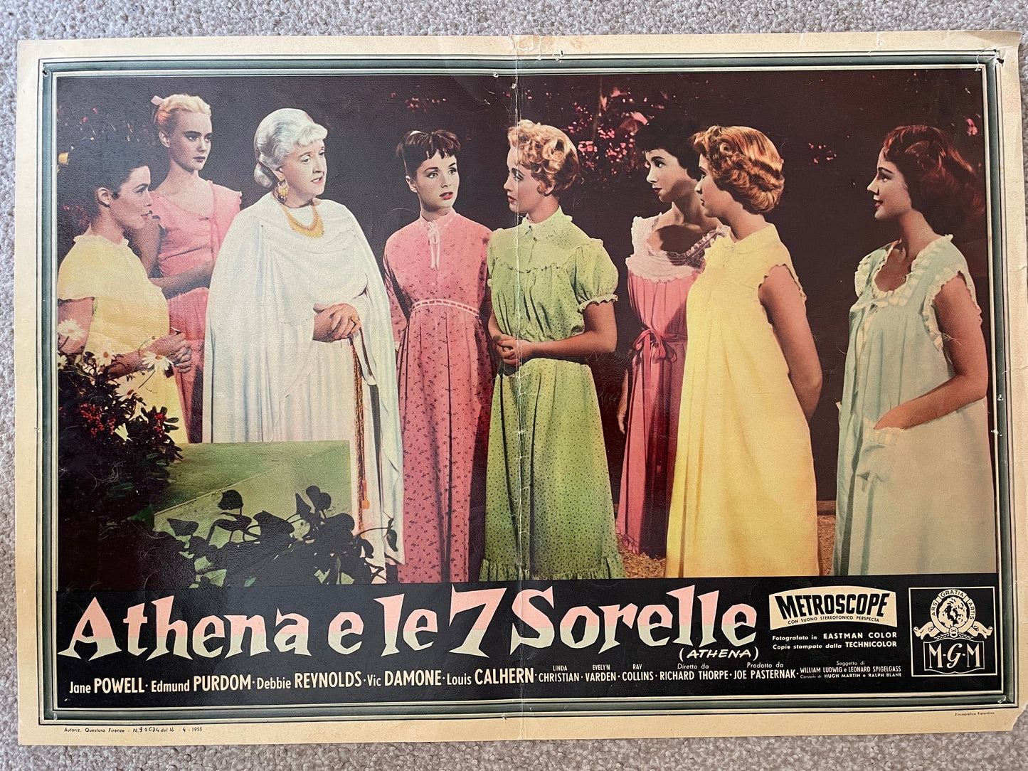 Vintage Italian movie lobby card for 'Athena e le 7 Sorelle' (Athena), featuring seven women in colorful vintage dresses against a dark outdoor background, with title text at the bottom and Metrocope/MGM logos.