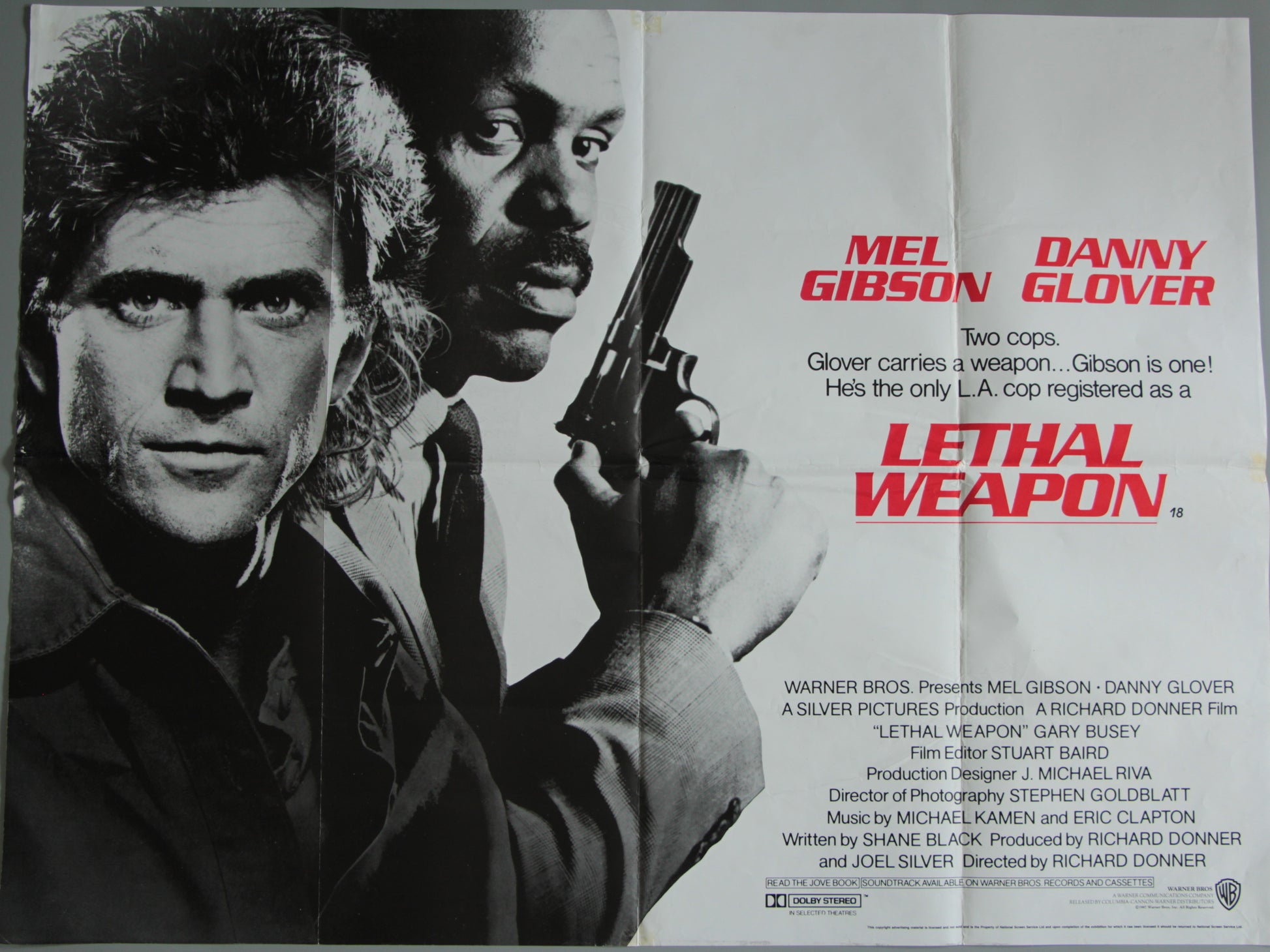 Movie poster for 'Lethal Weapon' featuring Mel Gibson and Danny Glover with a gun.